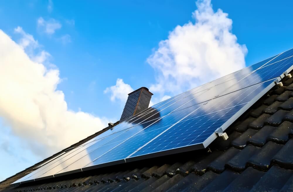 Solar panels producing clean energy on a roof of a residential house
