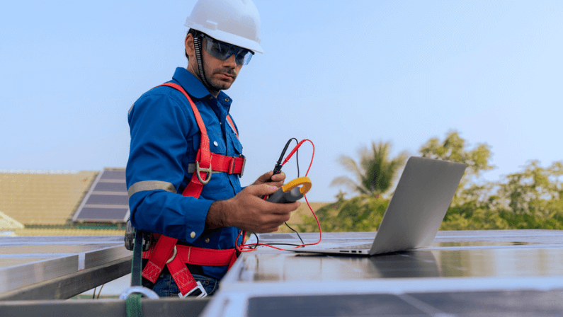 An Engineer use a laptop computer to examine, inspection the solar panels at roof top of home and home office ,concept of economic energy and cost saving